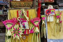 Altar decorated with colorful palm frond ornaments and piled with prayer offerings for Kuningan Day