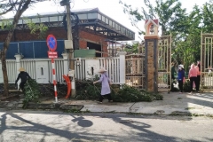 A nun helps workers clean up debris