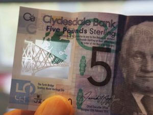 Clear window in a plastic five-pound note