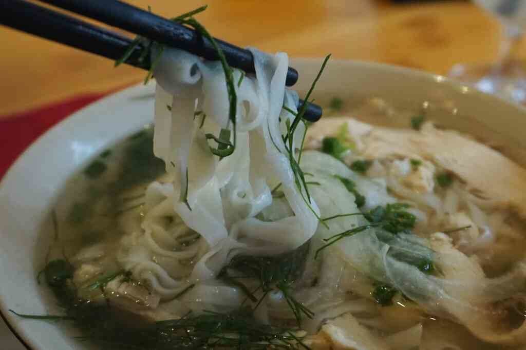 Fresh noodles in a steaming bowl of pho ga - Vietnamese chicken noodle soup