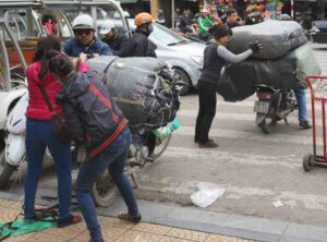 Loading holiday goods onto a motorbike