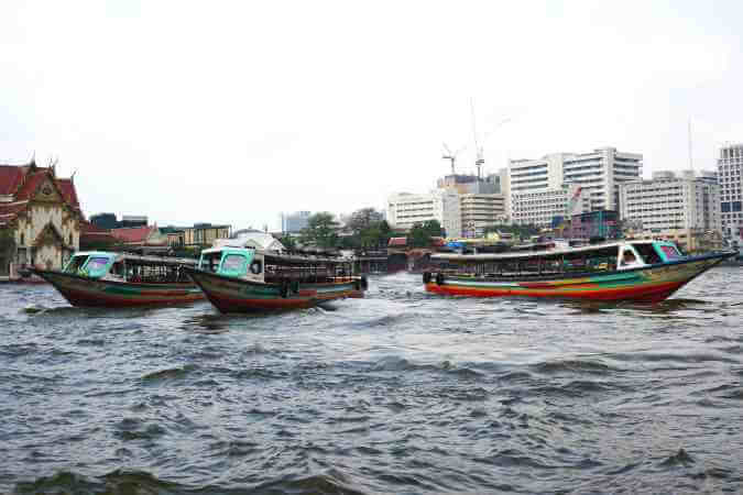 Colorful boats on Bangkok's busy Chao Phraya River