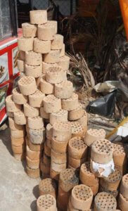 Burned out coal briquets piled outside a cafe in urban Vietnam