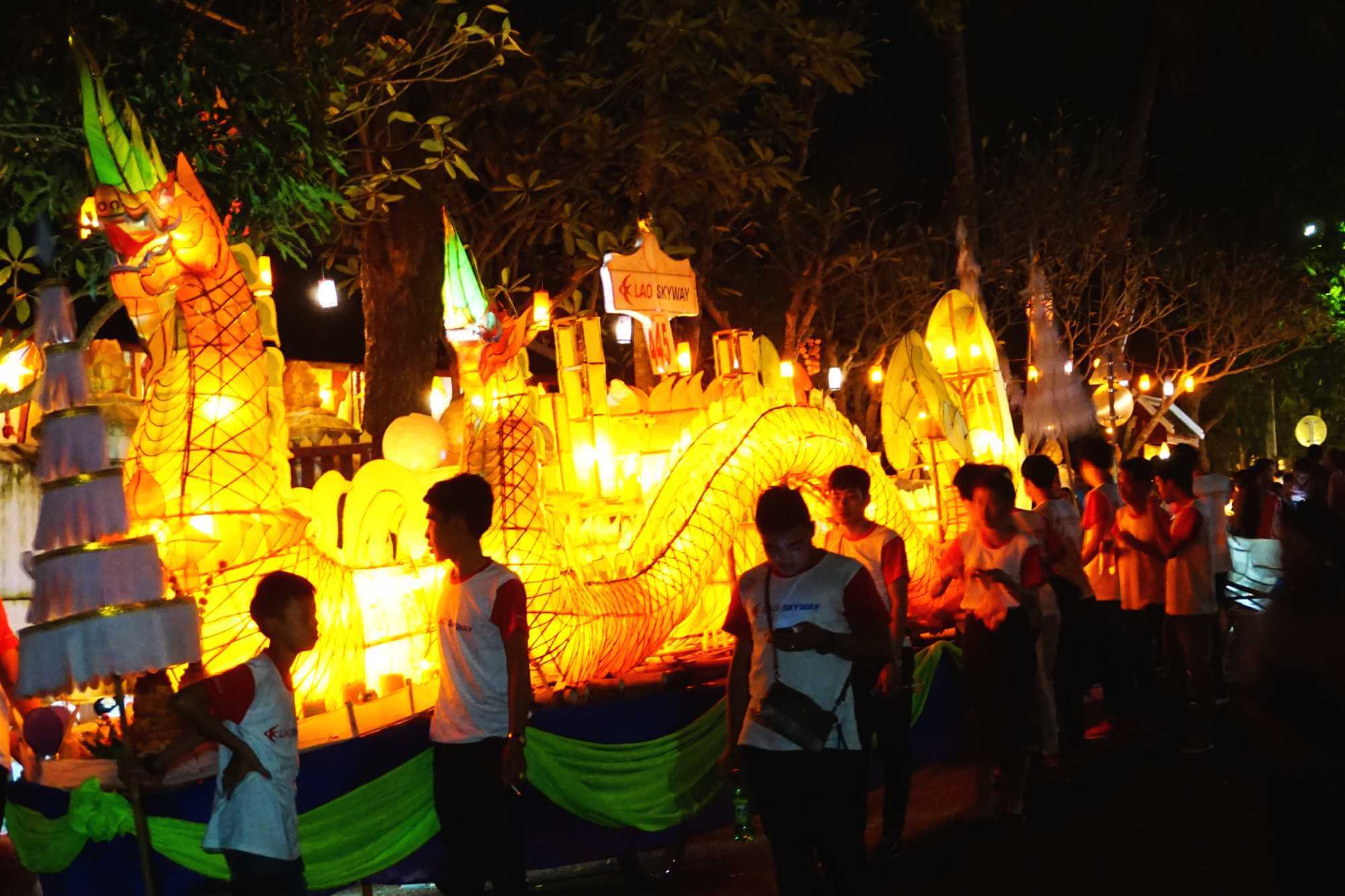 A lighted dragon float waits to join the procession for Boun Awk Phansa in Luang Prabang, Laos
