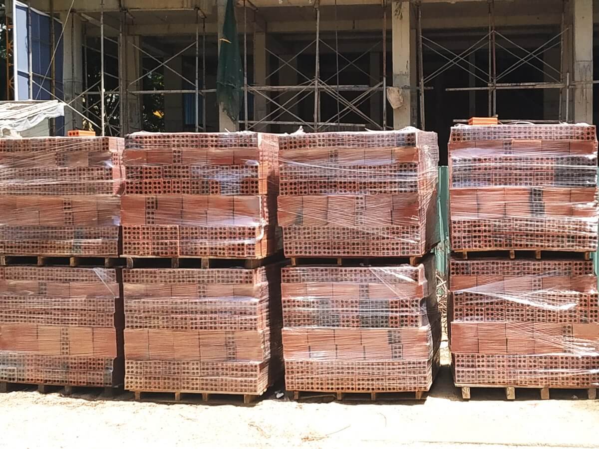 Clay building bricks stacked on pallets and wrapped in plastic