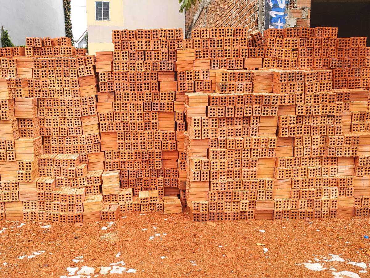 Bricks piled neatly on the ground at a Vietnamese construction site