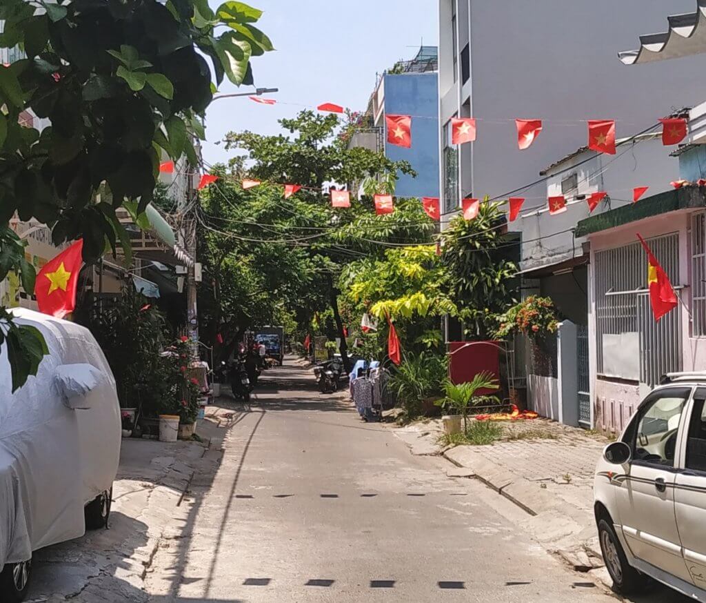 Vietnamese flags above a residential street in Da Nang
