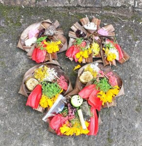 Prayer offerings arranged on the sidewalk in Bali