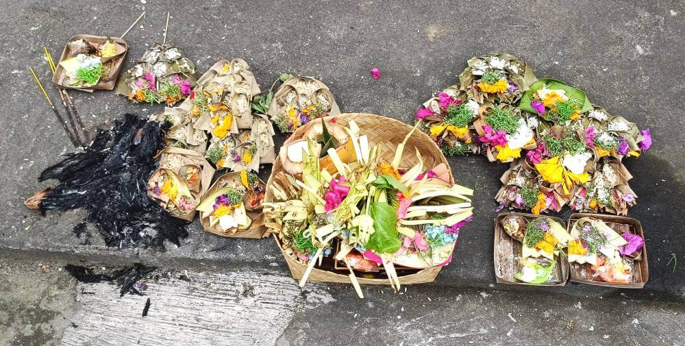 Colorful offerings on a sidewalk in Bali, Indonesia