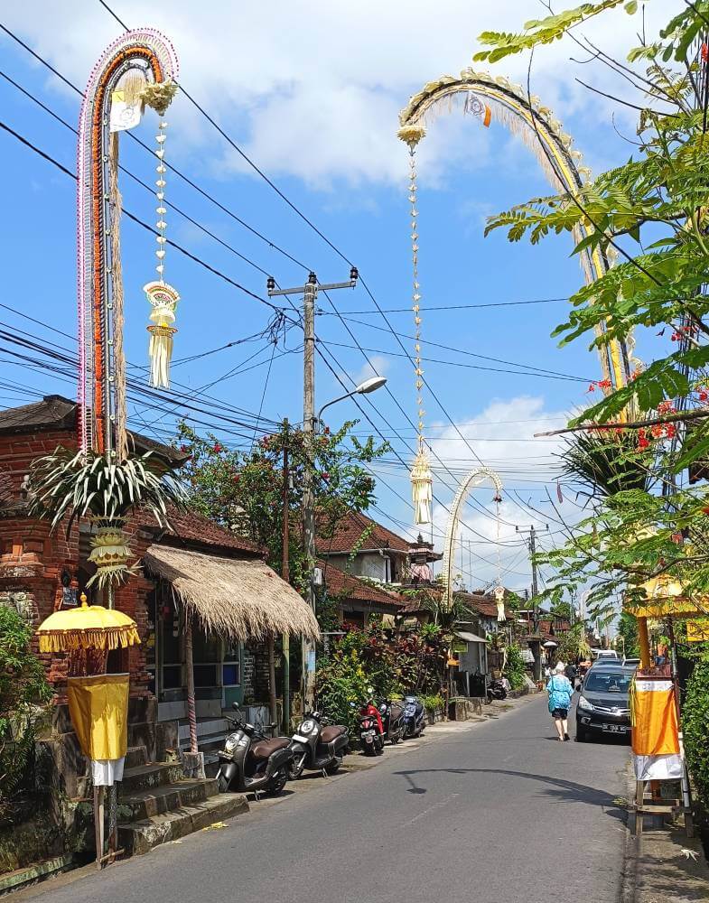 Extravagantly decorated penjors stand out on a sunny day in Bali