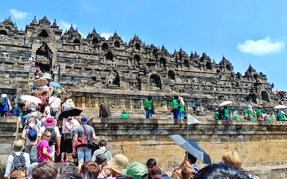 A crowd of visitors climb the stairs onto Borobudur temple near Yogyakarta, Indonesia