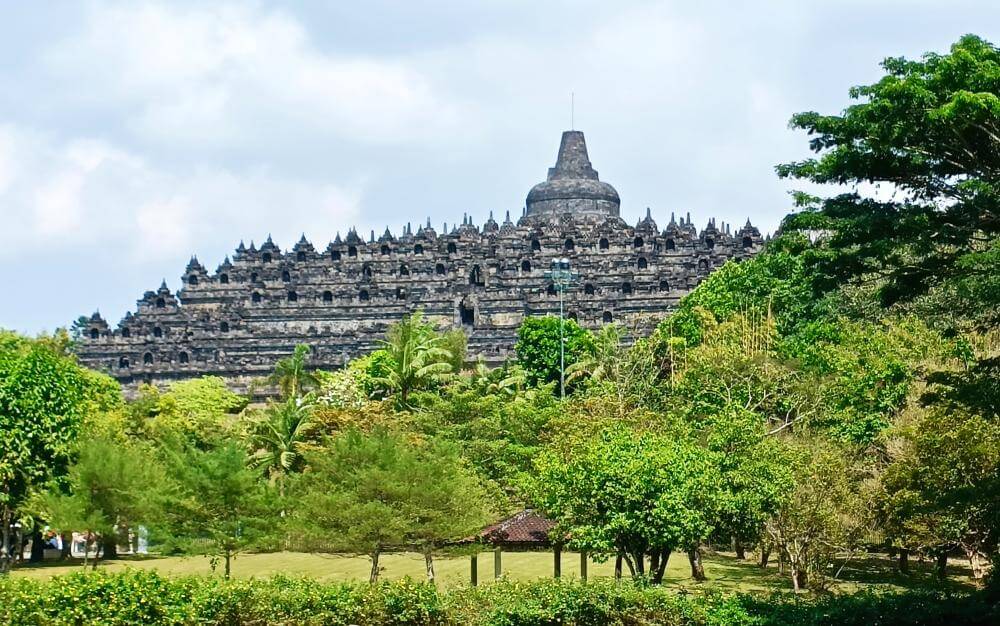 View of Borobudur temple looming on the hilltop ahead