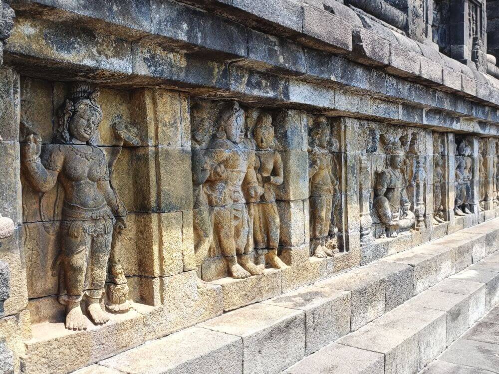 Detail of some of the carved stone reliefs that decorate the walls at the Borobudur temple complex near Yogyakarta, Indonesia