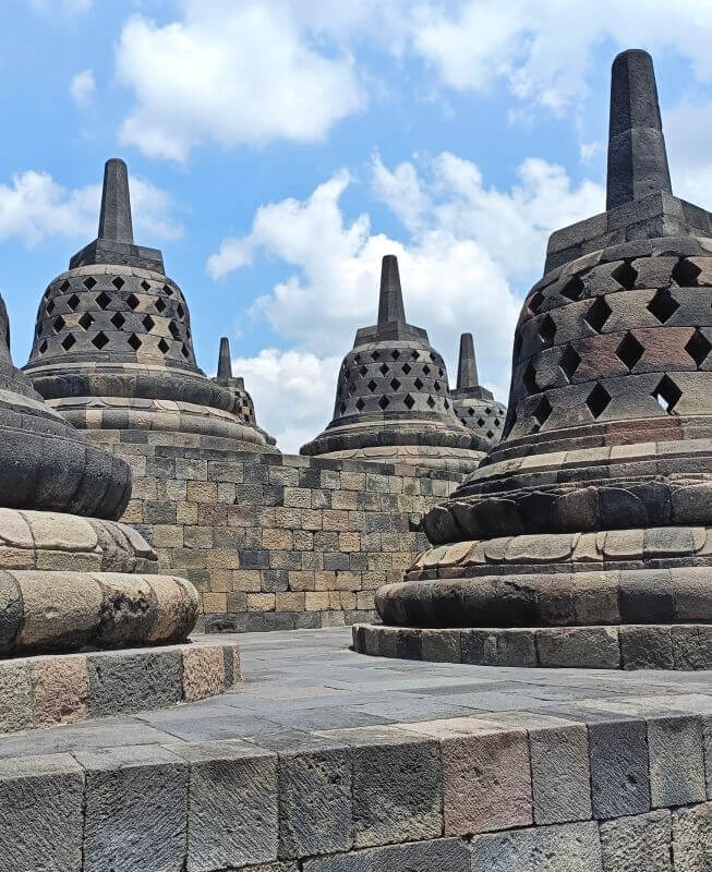 Several perforated stone stupas on an upper level of Borobudur temple near Yogyakarta, Indonesia